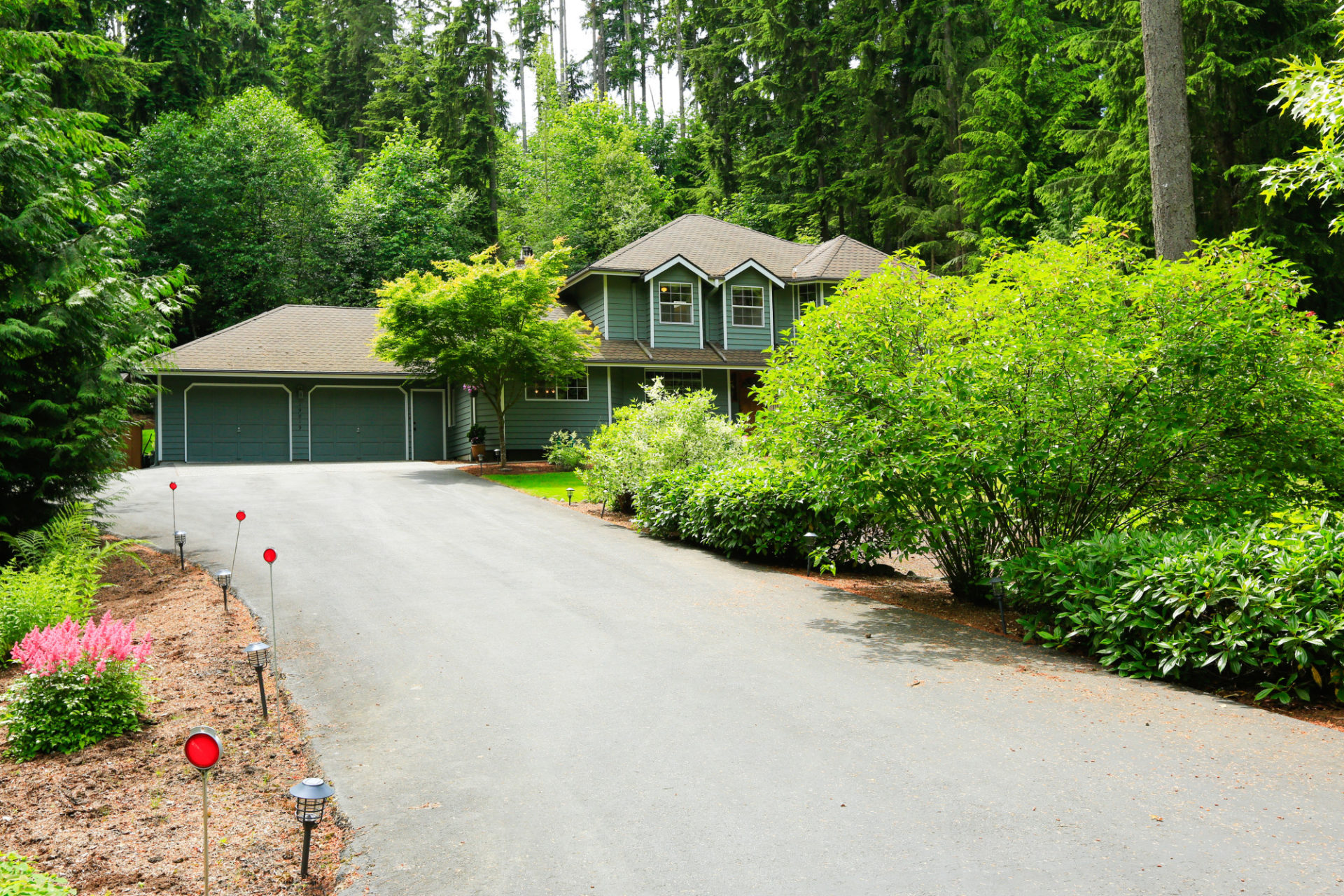 Luxury countryside house exterior. Asphat driveway